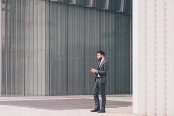 Confident and professional elegant bearded businessman posing outdoor