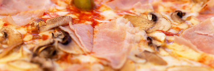 Fresh tasty pizza with bacon, mushrooms and olives close-up. Banner. Selective focus, defocus