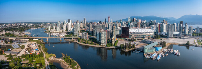 Vancouver, BC, Canada - panoramic aerial city view of famous False Creek in Vancouver downtown with Cambie Bridge and BC Place Stadium in front and Vancouver Skyline in the background 
