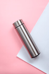 Aluminium reusable steel stainless eco thermo water bottle with mockup on pink white  background 
