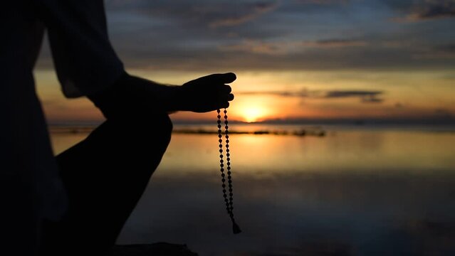 meditation on the beads closeup, meeting the sunrise on the seashore, meditation in the lotus position at sunrise and sunset