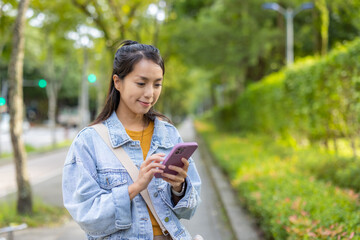 Woman use of mobile phone at park
