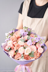 Beautiful bouquet of flowers in woman hand. Floral shop concept . Beautiful fresh cut bouquet. Flowers delivery
