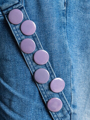 gray  round badge button on denim jacket. Badge on a  jacket close-up view. Texture Background