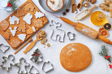 Christmas gingerbread different shaped with sugar icing and ingredients for gingerbread on wooden table, top view, flat lay