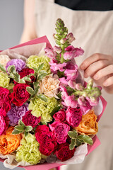 Beautiful bouquet of flowers in woman hand. Floral shop concept . Beautiful fresh cut bouquet. Flowers delivery