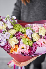 Beautiful bouquet of flowers in woman hand. Floral shop concept . Beautiful fresh cut bouquet. Flowers delivery
