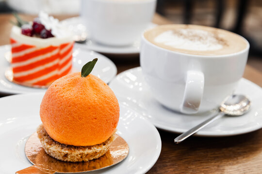 Colorful sweet cakes and coffee, close up photo