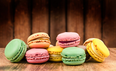 Traditional French colorful macaroons on wooden background