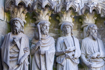 Sculptural images of the Holy Apostles on the wall of the facade of Saint Fin Barre's Cathedral in...