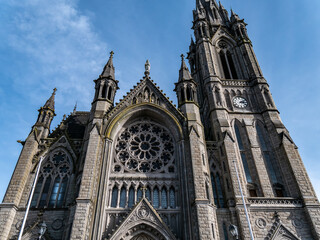 Fototapeta premium Catholic Cathedral in Ireland, Gothic style. The Cathedral Church of St Colman known as Cobh Cathedral, or Queenstown Cathedral, single-spire cathedral, Ireland. Roman Catholic cathedral.