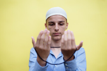 young muslim man praying, concept of peace, harmony and happy life filled with belief in God