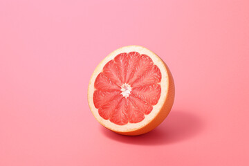 Red orange cut on a pink background. High quality photo Generative AI