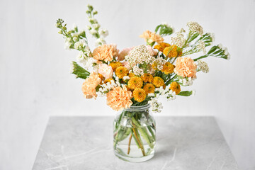 Finished flower arrangement in a vase for home. Flowers bunch, set for interior. Fresh cut flowers for decoration home. European floral shop. Delivery fresh cut flower.