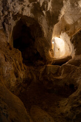 inside a dark cave with walls eroded by the passage of time
