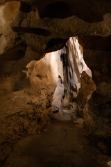 interior of an ancient cave with a narrow corridor at the bottom