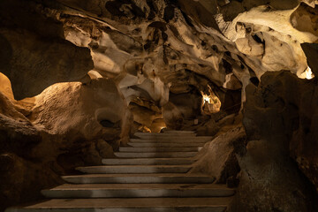 general horizontal contrapposto shot of the floor and ceiling of the rock formations of the cave of...