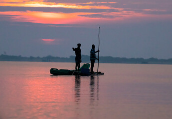 Fishermen silhouette photo in a lake at early morning 