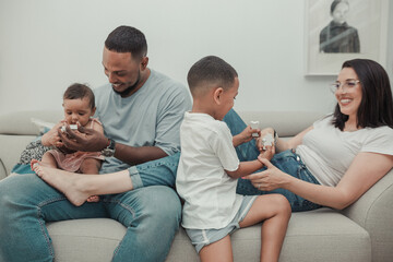 Relaxed multicultural family playing together on the sofa