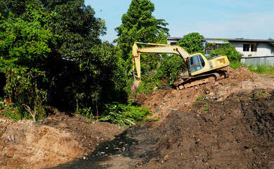 excavator on a construction site. excavator in the ground. Excavators are digging clogged canals to...