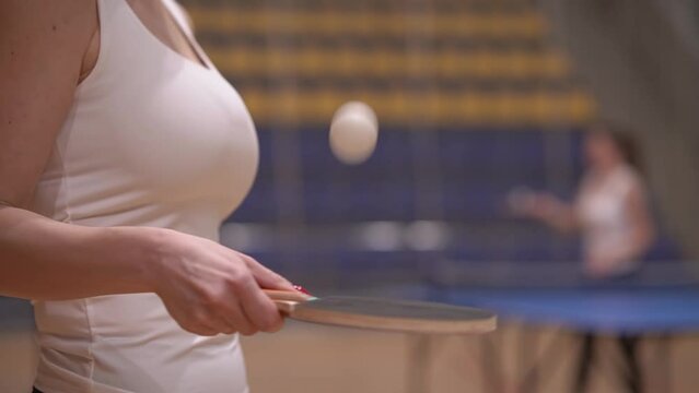 Table tennis. the blonde hits the ball with a racket. real time video. woman trains playing table tennis close-up. High quality Full HD video recording