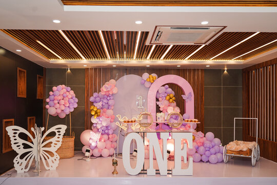 First birthday party decoration with a pastel pink, purple set up with cake, candy and sweets. 
