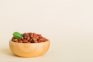 Fresh healthy peanuts in bowl on colored table background. Top view Healthy eating bertholletia concept. Super foods