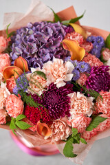 Beautiful bouquet of mixed flowers in woman hand. Floral shop concept . Beautiful fresh cut bouquet. Flowers delivery