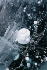Naklejka na ściany i meble Gas methane bubbles frozen in blue ice of lake Baikal