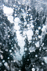 Fototapeta premium Gas methane bubbles frozen in blue ice of lake Baikal