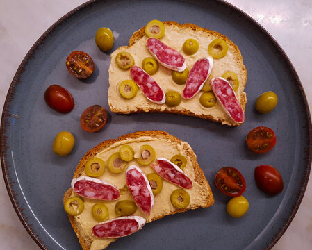 tosts with fuet, tomato and olives