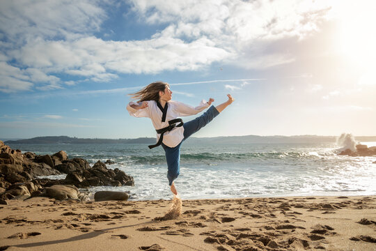 Beachside Warrior: Capturing the Skill and Determination of a Young Woman's Taekwondo Kick