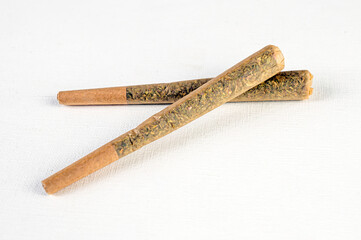 Marijuana joint pre-rolled cone paper on white background, roll paper cannabis - obrazy, fototapety, plakaty