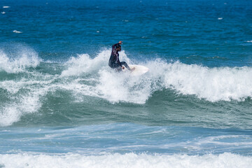 Surfer riding waves in Furadouro Beach