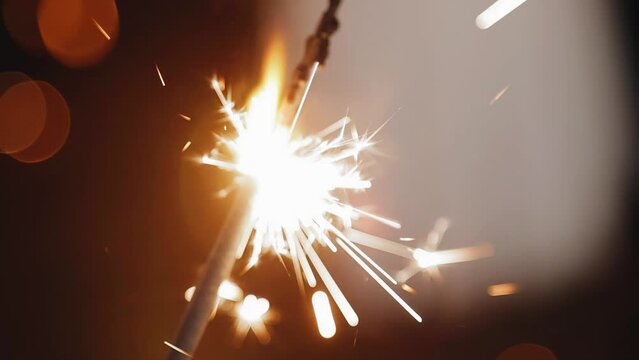 Close-up of a burning firework in the hands of a man. Shooting on holiday
