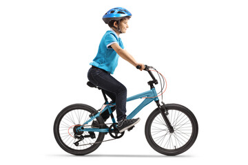 Profile shot of a boy riding a bicycle with a helmet