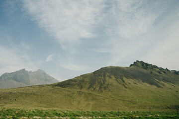 Fototapeta na wymiar Scenic view of green landscape against sky at Iceland