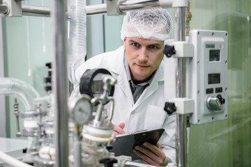 A researcher is investigating quality and analyzing cannabis plants. Herbal alternative for medicine. Scientist extracting cannabis oil in a laboratory.