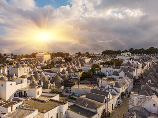 Aerial view of Alberobello, city of Trulli in Itria Valley, Puglia. Traditional Apulian dry stone huts with a conical roof in the Murge area of the Italian region of Apulia. - obrazy, fototapety, plakaty
