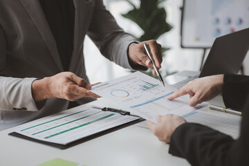 Two businessmen pointed to the material for the meeting, working together to plan to develop and solve common business problems. Concept of business management for growth and quality.