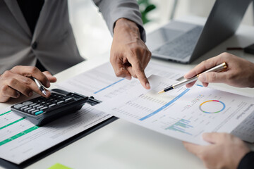 Two businessmen pointed to the material for the meeting, working together to plan to develop and solve common business problems. Concept of business management for growth and quality.