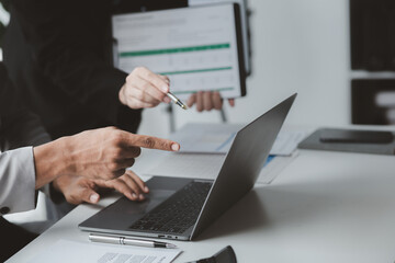 Two businessmen pointed to the material for the meeting, working together to plan to develop and solve common business problems. Concept of business management for growth and quality.