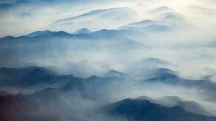 An aerial shot of Mt Hood with fog laying in the valleys surrounding the mountain, near Portland,...