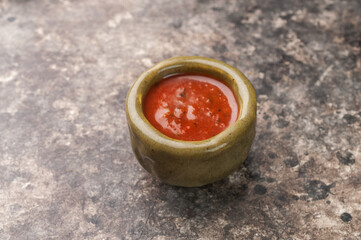 spicy tomato ketchup sauce on gray background