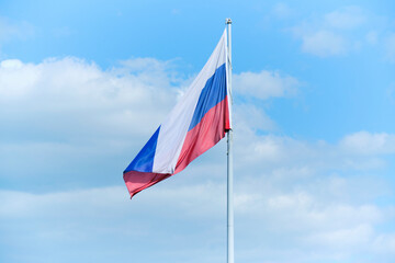 Tricolor, flag Russian Federation blue sky background.