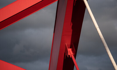 Ostroda, Poland - May 26, 2022: Independence Bridge in Ostroda. A steel, red structure in the rays...