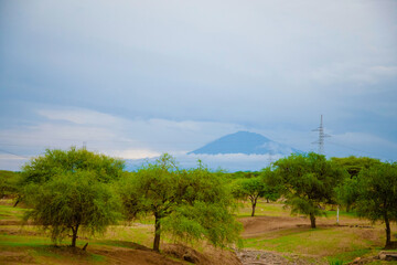Aerial Mount Kilimanjaro Africa's highest mountain snow and white puffy clouds from Tanzania.