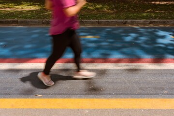 Athlete woman practicing running on the track at Ibirapuera park in Sao Paulo city, Brazil.