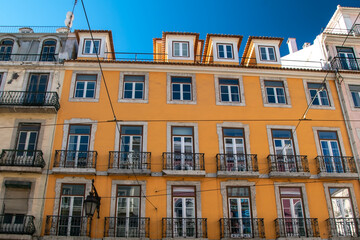 Fototapeta na wymiar Facade of an old house with windows, European historical buildings, cozy cityscape, Portuguese streets landscape, view of city 