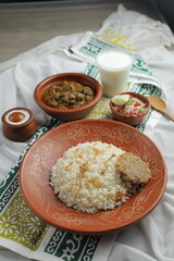 Mezbani Beef korma karahi khichuri rice Combo with salad, borhani and baked gulab jamun served in dish isolated on mat top view of indian and bangladeshi food
